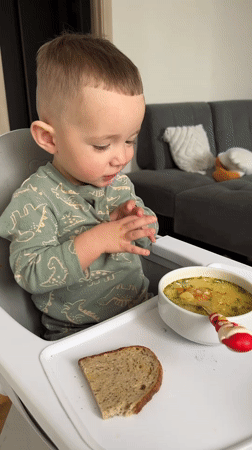 Child enjoys mealtime in high chair in Odintsovo home
