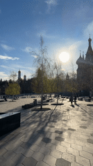 Person walks through sunny Moscow park on spring afternoon