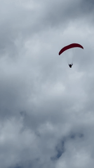 Paraglider spotted descending over Fethiye mountains in Turkey