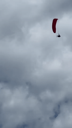 Paraglider spotted descending over Fethiye mountains in Turkey
