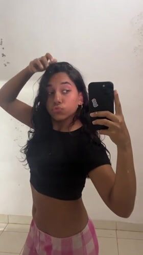 Woman takes selfie in Pampatar, Venezuela early morning