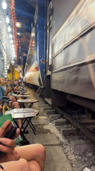 Hanoi's Train Street: café tables inches from a passing locomotive