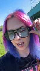Woman with colorful hair films videos in Zagreb park