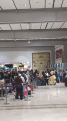 Morning airport scenes at Soekarno-Hatta: check-in queues, carts, and coffee