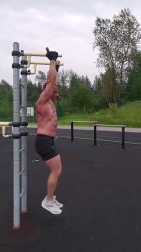 Street workout session at an outdoor fitness station in Kizel