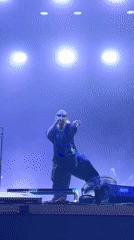 Concert set with bold lighting and a skull-themed stage backdrop.