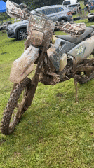 Muddy dirt bike spotted at outdoor gathering in Bulgaria