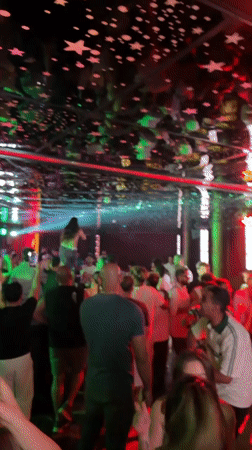 Crowded nightclub in Sharm El Sheikh under star-patterned mirrored ceiling