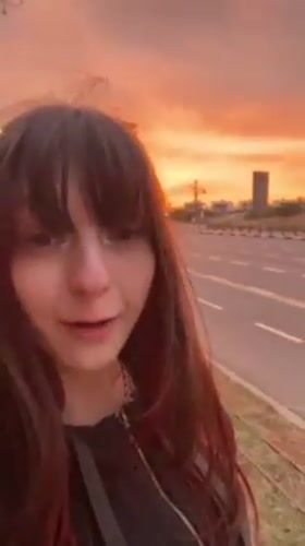 Woman documents sunset selfie session across Herzliya streets