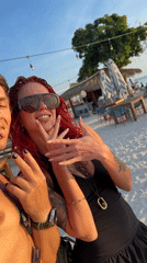 Couple takes selfies at decorated Indonesian beach during sunrise