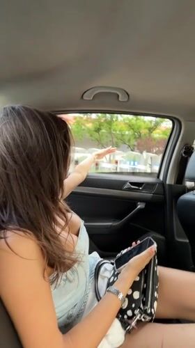 Woman observed using phone in moving car, Chaoyang District