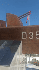 Touring an open-air naval memorial with decommissioned military hardware