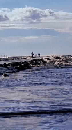 Afternoon on Riga's breakwater pier, lighthouse in view