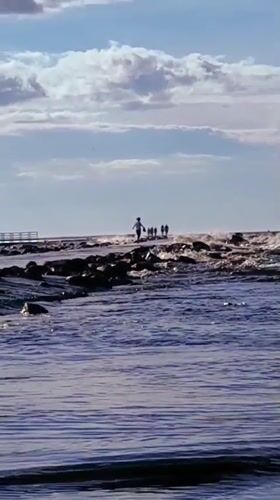 Afternoon on Riga's breakwater pier, lighthouse in view