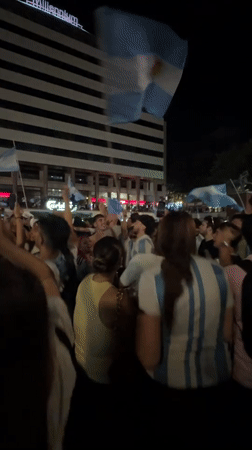 Argentine fans celebrate in Porto city square at night
