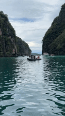 Boats navigating Ao Nang's turquoise waters beneath karst cliffs