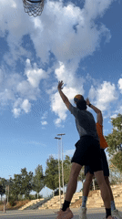 Outdoor pickup basketball in Tarragona, with a skatepark sunset
