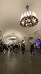 Morning commuters navigate ornate Moscow subway station platform