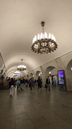 Morning commuters navigate ornate Moscow subway station platform