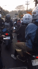 Motorcycle traffic stacks up at a Pasirmuncang railway crossing