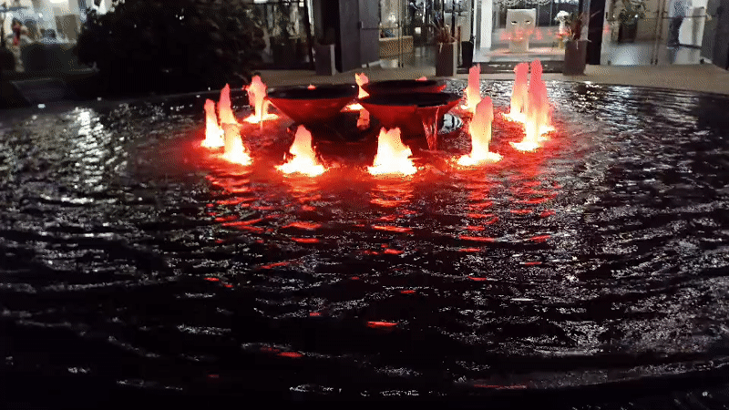 Illuminated fountains and water features in Abano Terme at dusk