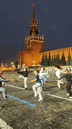 Acrobatic group performs handstands on Red Square at dusk