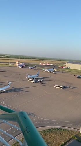 Astana airport tarmac from above, planes parked on a sunny day