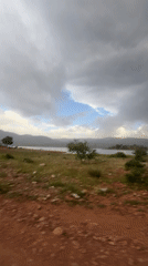 Visitor documents scenic views of Bin El Ouidane reservoir, Morocco