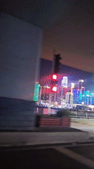 Nighttime drive captured through illuminated Yuzhong District skyline