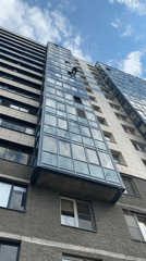 Window cleaner works on tall residential building exterior