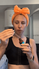Woman applies skincare products during morning routine in Montenegro