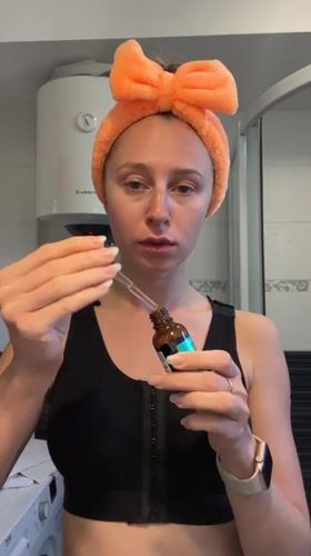Woman applies skincare products during morning routine in Montenegro
