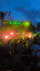 DJ performs under colorful lights and smoke in Sant Cugat
