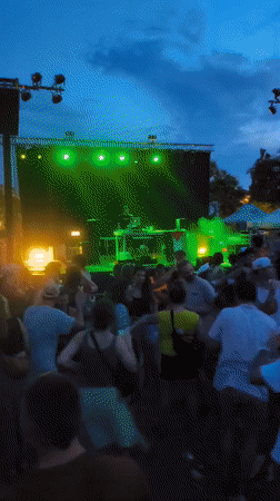 DJ performs under colorful lights and smoke in Sant Cugat