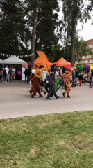 Animal mascots and a wireframe puppet at an outdoor event