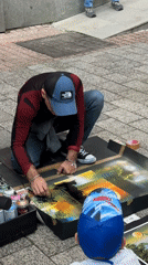 Street artist performs spray paint demo in Plovdiv pedestrian area