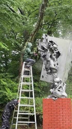 Wet forest, flowing water, and sculpture maintenance in Hakone