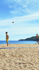 Men play beach volleyball on sunny Montenegro coast