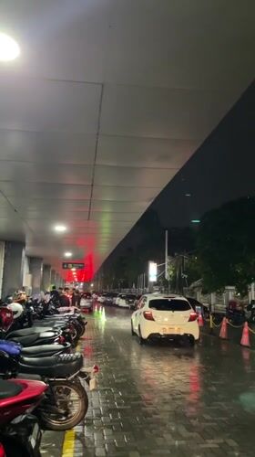 Rainy night scene captured in Madiun with parked motorcycles