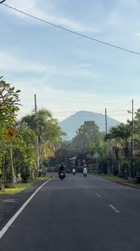 Motorbikes travel tropical road in Selemadeg Barat, Indonesia