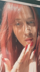 Digital screen shows image of red-haired woman with freckles