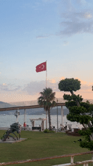Waterfront promenade glows under a pink and orange sky