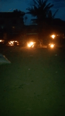 Evening street vendor scene with fires documented by witnesses