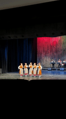 Traditional folk performance captured alongside street scene in Ruse