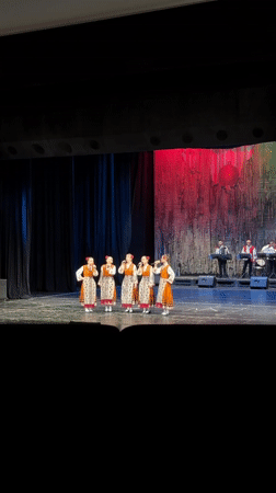 Traditional folk performance captured alongside street scene in Ruse