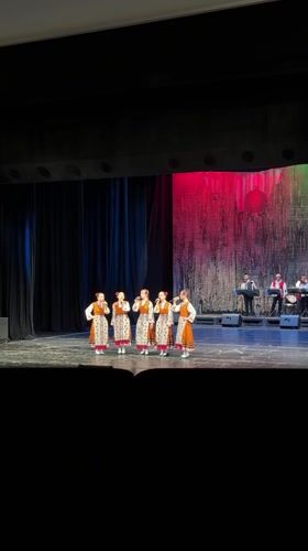 Traditional folk performance captured alongside street scene in Ruse