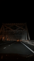 Night drive through rural Russia, bridge crossing in the rain