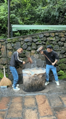 Men pound substance with mallets in traditional preparation, Xiehe
