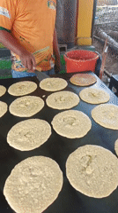Street vendor cooks flatbreads on griddle in Tinaquillo