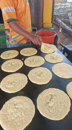 Street vendor cooks flatbreads on griddle in Tinaquillo
